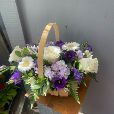 Trug arrangment  - An arrangement in oasis, in purples and whites 