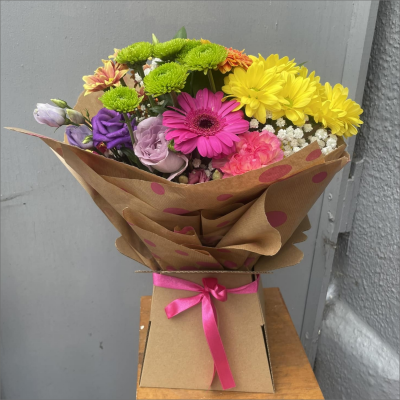 Splash of Colour - A vibrant gerbera posy hand-tied featuring a mix of colours carefully selected by the local florist. Hand-delivered in a gift bag or box.