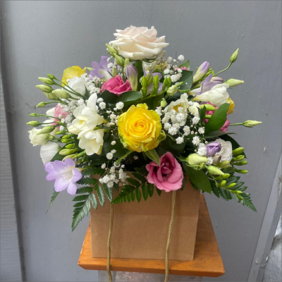 A Little Something - Show your affection with this mouth-watering mix of classical flowers delivered in a delightful gift bag or box.