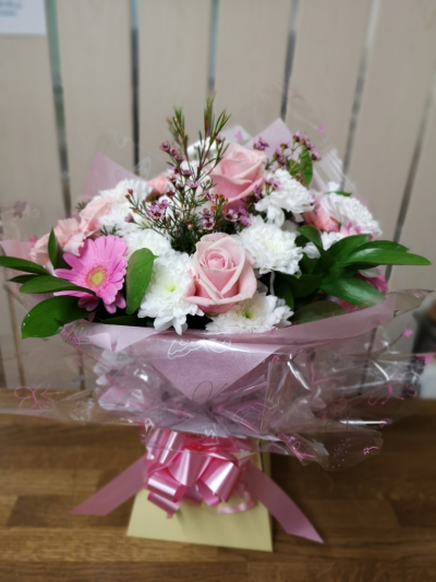 Hand-Tied aqua pack - AQUA PACK This arrangement can be made with the customer choosing the preferred colour scheme of wrapping and flowers and the florist making the item .