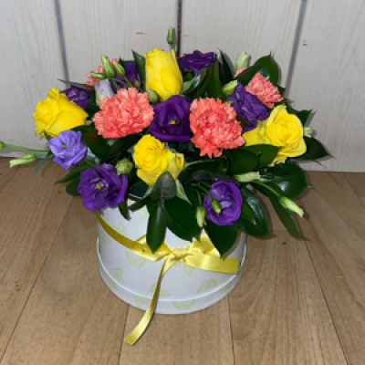 Citrus hatbox  - An oasis arrangement in a hatbox in yellows , oranges and purples (Picture is standard for reference 