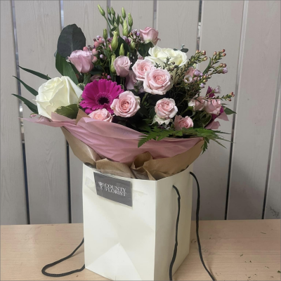 Warm Wishes - Send this vibrant hand-tied featuring a mix of favourite flowers delivered in a delightful gift bag or box is the perfect way to send your thoughts.