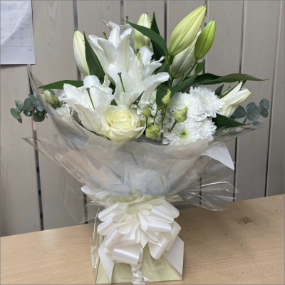 Evelyn - A fabulous collection of white and cream flowers make this the perfect gift. This bouquet will be hand delivered by the local florist.